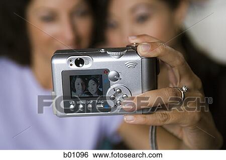 Close-up of a camera in a woman's hand View Large Photo Image Stock Photograph - Close-up of a camera in a woman's hand. Fotosearch
