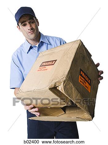 Close-up of a delivery man holding a crate View Large Photo Image Stock Image - Close-up of a delivery man holding a crate. Fotosearch