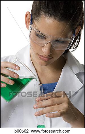 Close-up of a female technician pouring liquid from a beaker into a test tube View Large Photo Image Stock Image - Close-up of a female technician pouring liquid from a beaker into a test tube. Fotosearch