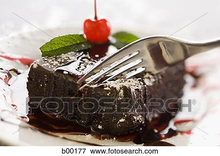 Close-up of a fork on a slice of cake View Large Photo Image Stock Photo - Close-up of a fork on a slice of cake. Fotosearch