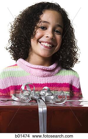 Close-up of a girl holding a gift box View Large Photo Image Picture - Close-up of a girl holding a gift box. Fotosearch