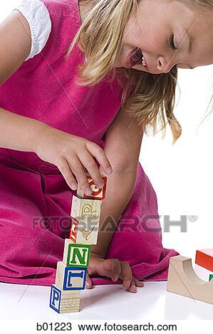 Close-up of a girl playing with blocks View Large Photo Image Stock Image - Close-up of a girl playing with blocks. Fotosearch