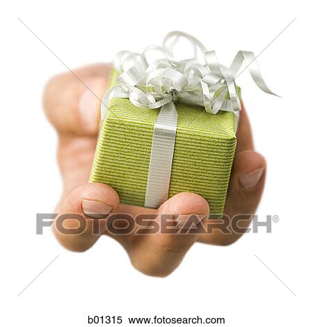 Close-up of a hand holding a gift View Large Photo Image Stock Photography - Close-up of a hand holding a gift. Fotosearch