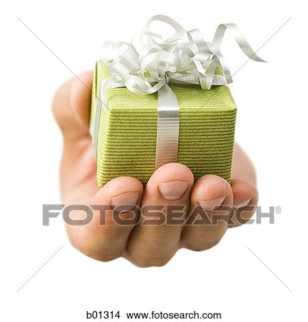 Close-up of a hand holding a small gift View Large Photo Image Picture - Close-up of a hand holding a small gift. Fotosearch