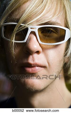 Close-up of a hip young man wearing sunglasses View Large Photo Image Stock Image - Close-up of a hip young man wearing sunglasses. Fotosearch