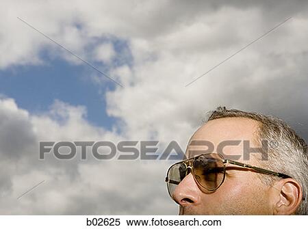 Stock Photography - Close-up of a human head wearing sunglasses. Fotosearch