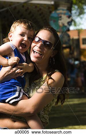 Close-up of a mother holding her son View Large Photo Image Stock Photography - Close-up of a mother holding her son. Fotosearch