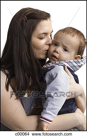 Close-up of a mother kissing her son View Large Photo Image Picture - Close-up of a mother kissing her son. Fotosearch