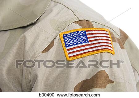 Stock Image - Close-up of a patch of an American flag on soldier's uniform. Fotosearch