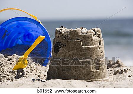 Close-up of a sand pail and shovel lying near a sand castle View Large Photo Image Stock Image - Close-up of a sand pail and shovel lying near a sand castle. Fotosearch