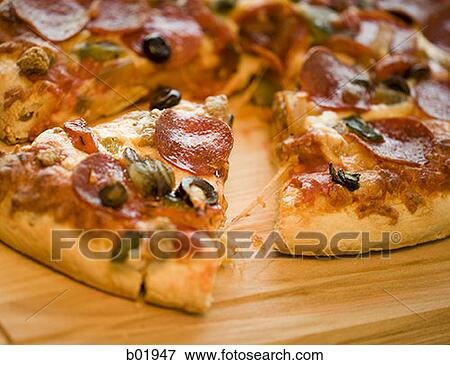 Close-up of a sliced pizza View Large Photo Image Stock Photo - Close-up of a sliced pizza. Fotosearch