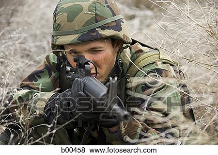 Close-up of a soldier aiming his rifle View Large Photo Image Stock Photo - Close-up of a soldier aiming his rifle. Fotosearch