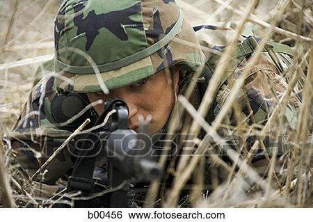 Close-up of a soldier aiming his rifle View Large Photo Image Stock Photograph - Close-up of a soldier aiming his rifle. Fotosearch