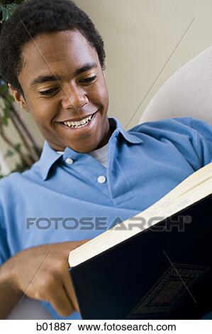 Close-up of a teenage boy reading a book View Large Photo Image Stock Photo - Close-up of a teenage boy reading a book. Fotosearch