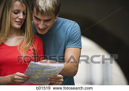 Close-up of a teenage couple looking at a map View Large Photo Image Stock Photo - Close-up of a teenage couple looking at a map. Fotosearch