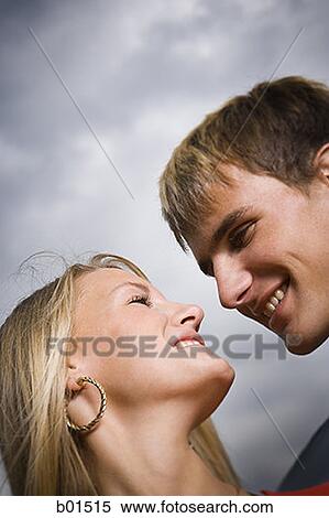 Close-up of a teenage couple looking at each other View Large Photo Image Stock Photography - Close-up of a teenage couple looking at each other. Fotosearch