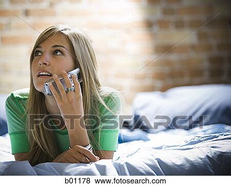 Close-up of a teenage girl talking on a mobile phone View Large Photo Image Stock Photo - Close-up of a teenage girl talking on a mobile phone. Fotosearch