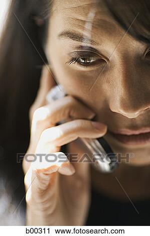 Close-up of a woman talking on a mobile phone View Large Photo Image Stock Image - Close-up of a woman talking on a mobile phone. Fotosearch