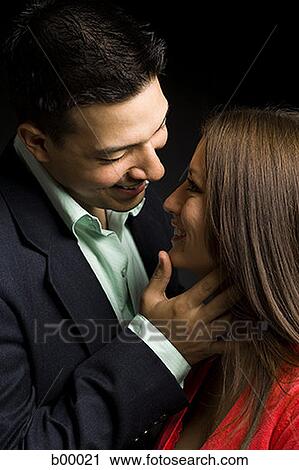 Close-up of a young couple smiling View Large Photo Image Stock Image - Close-up of a young couple smiling. Fotosearch