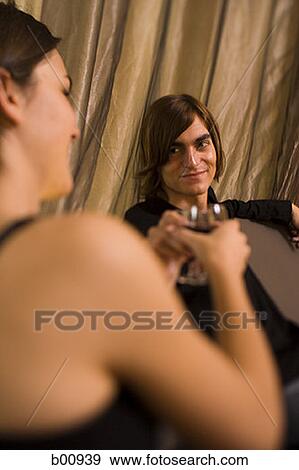 Stock Photo - Close-up of a young couple toasting. Fotosearch