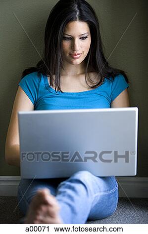 Close-up of a young Latin woman using a laptop View Large Photo Image Stock Image - Close-up of a young Latin woman using a laptop. Fotosearch