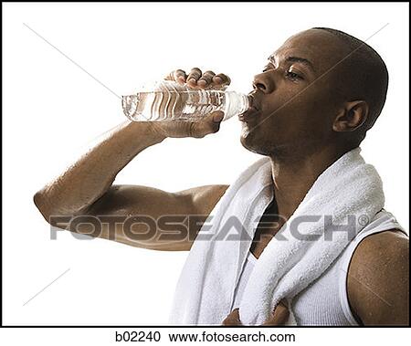 Close-up of a young man drinking water from a bottle View Large Photo Image Stock Image - Close-up of a young man drinking water from a bottle. Fotosearch