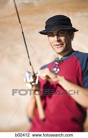 Close-up of a young man fishing View Large Photo Image Stock Image - Close-up of a young man fishing. Fotosearch