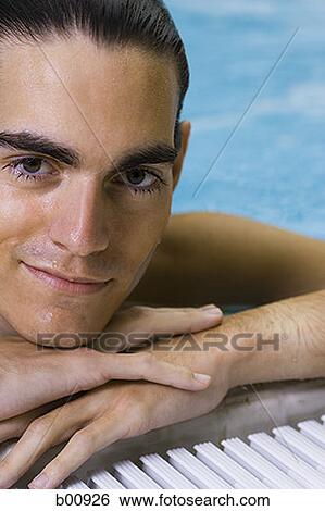 Close-up of a young man in a swimming pool View Large Photo Image Stock Photograph - Close-up of a young man in a swimming pool. Fotosearch