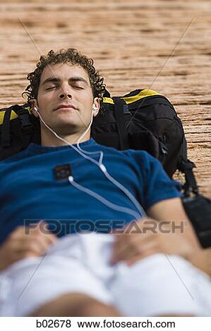 Close-up of a young man lying on his back View Large Photo Image Stock Photo - Close-up of a young man lying on his back. Fotosearch