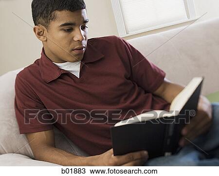 Close-up of a young man reading a book View Large Photo Image Stock Image - Close-up of a young man reading a book. Fotosearch