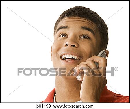 Stock Photo - Close-up of a young man talking on a mobile phone. Fotosearch