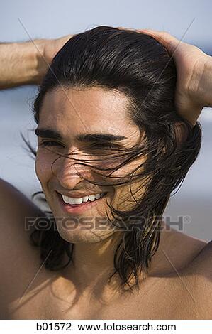 Close-up of a young man with his hands in his hair View Large Photo Image Stock Image - Close-up of a young man with his hands in his hair. Fotosearch