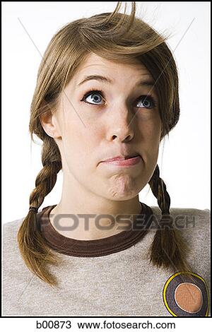 Close-up of a young woman blowing on her hair View Large Photo Image Stock Image - Close-up of a young woman blowing on her hair. Fotosearch