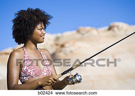 Close-up of a young woman fishing View Large Photo Image Picture - Close-up of a young woman fishing. Fotosearch