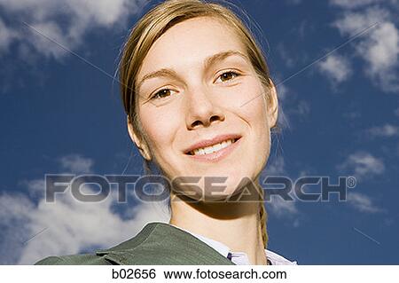Stock Photograph - Close-up of a young woman looking at the camera. Fotosearch