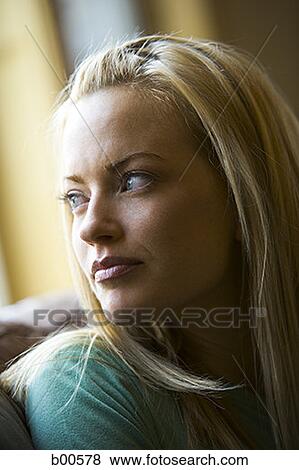Close-up of a young woman looking over her shoulder View Large Photo Image Stock Photo - Close-up of a young woman looking over her shoulder. Fotosearch