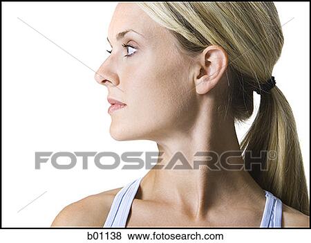 Close-up of a young woman looking sideways View Large Photo Image Stock Photo - Close-up of a young woman looking sideways. Fotosearch