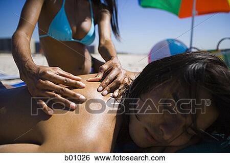 Close-up of a young woman massaging a young man's back View Large Photo Image Stock Photograph - Close-up of a young woman massaging a young man's back. Fotosearch