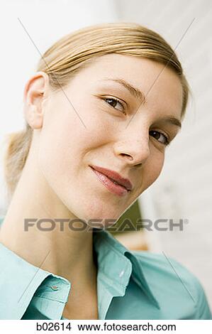 Close-up of a young woman smiling View Large Photo Image Picture - Close-up of a young woman smiling. Fotosearch