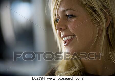 Close-up of a young woman smiling View Large Photo Image Picture - Close-up of a young woman smiling. Fotosearch