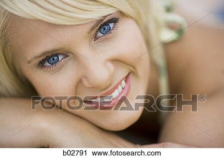 Close-up of a young woman smiling View Large Photo Image Stock Image - Close-up of a young woman smiling. Fotosearch