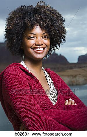 Close-up of a young woman smiling View Large Photo Image Stock Photo - Close-up of a young woman smiling. Fotosearch