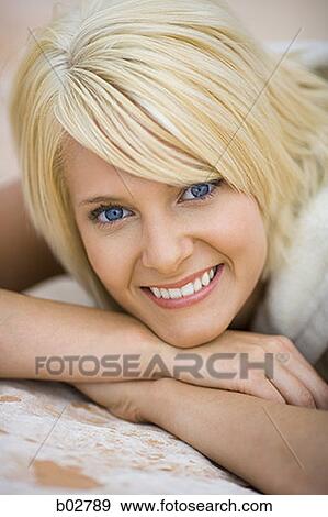Close-up of a young woman smiling View Large Photo Image Stock Photo - Close-up of a young woman smiling. Fotosearch