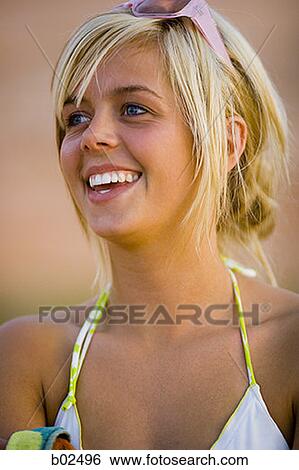 Close-up of a young woman smiling View Large Photo Image Stock Photograph - Close-up of a young woman smiling. Fotosearch