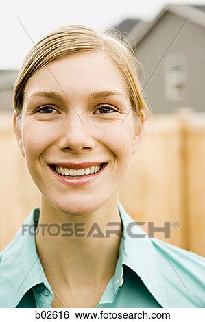 Stock Photograph - Close-up of a young woman smiling. Fotosearch