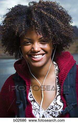 Stock Photograph - Close-up of a young woman smiling. Fotosearch