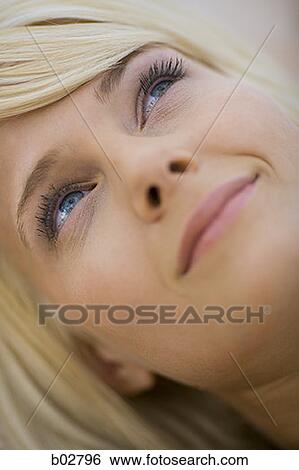 Close-up of a young woman smiling View Large Photo Image Stock Photograph - Close-up of a young woman smiling. Fotosearch