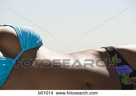 Close-up of a young woman sunbathing View Large Photo Image Picture - Close-up of a young woman sunbathing. Fotosearch