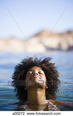 Close-up of a young woman swimming in a lake View Large Photo Image Stock Image - Close-up of a young woman swimming in a lake. Fotosearch