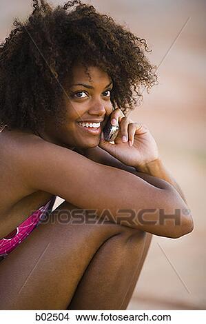 Close-up of a young woman talking on a mobile phone View Large Photo Image Picture - Close-up of a young woman talking on a mobile phone. Fotosearch